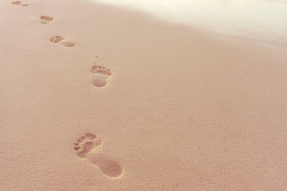 Menschliche Fußspuren im Sand am Strand